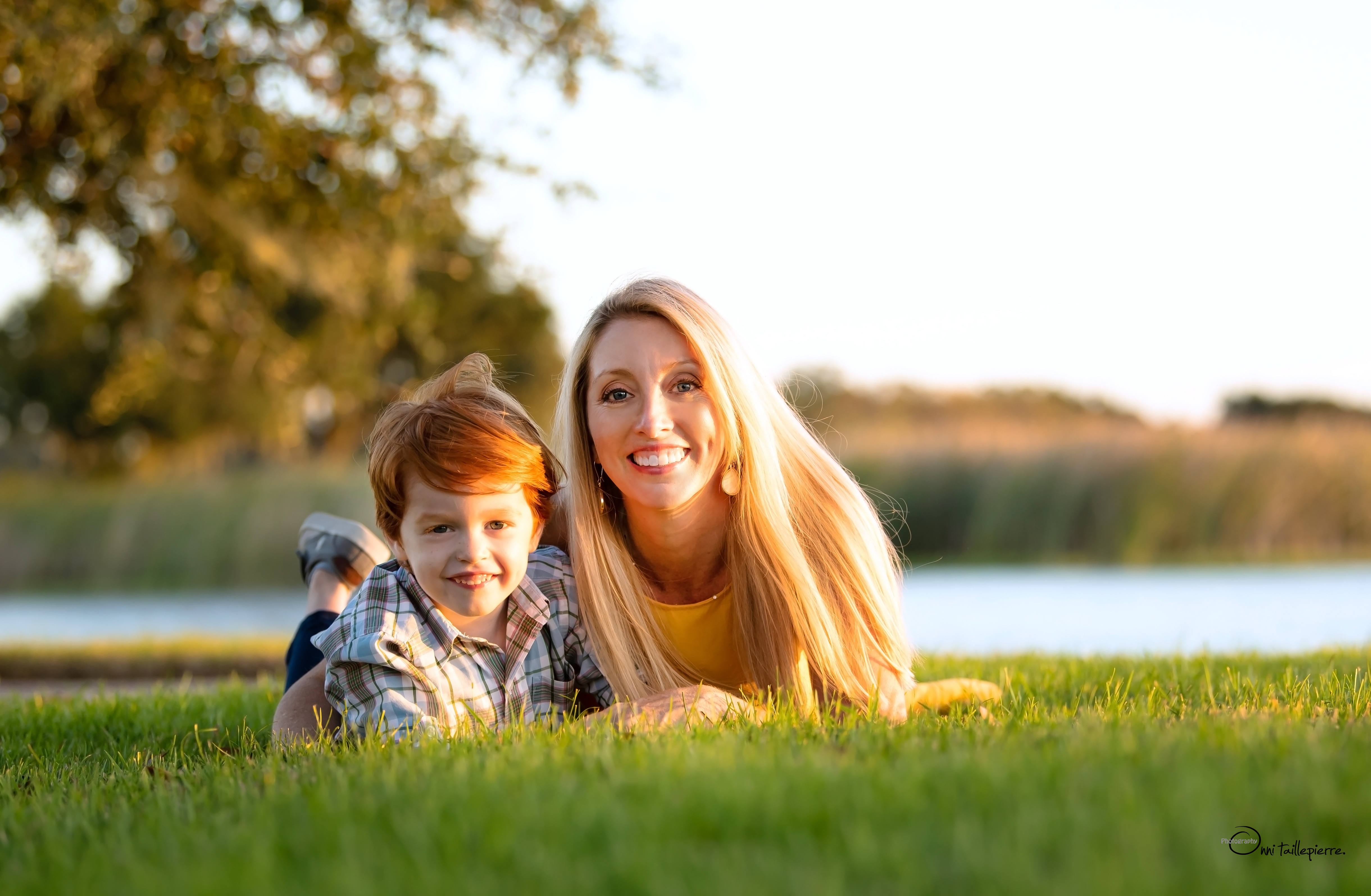 Dr. Boesch and her son lying in the grass